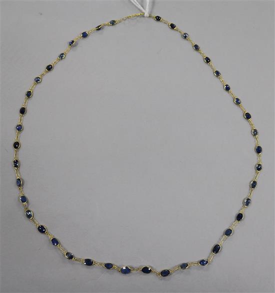 A 14ct gold and sapphire set spectacle necklace, 50cm.